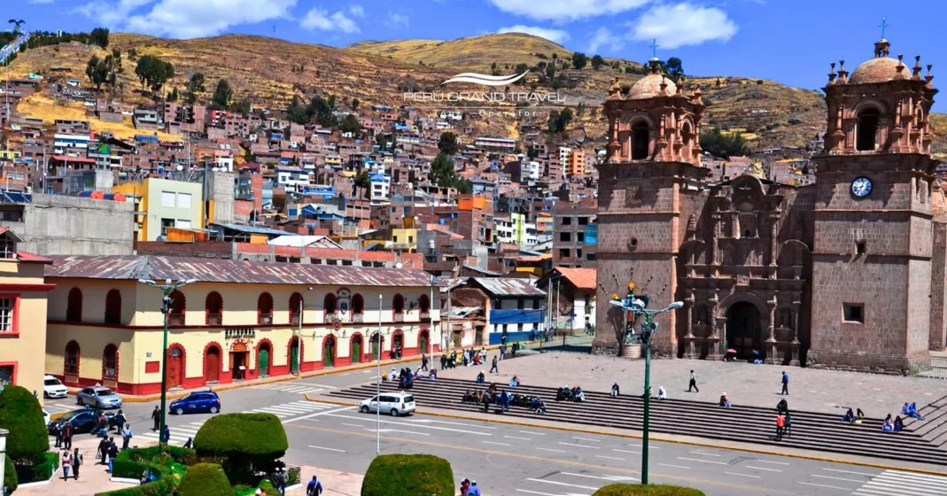 Aerial view of the Main Square of Puno showing the Cathedral Basilica, city streets, and colorful hillside neighborhoods around the plaza