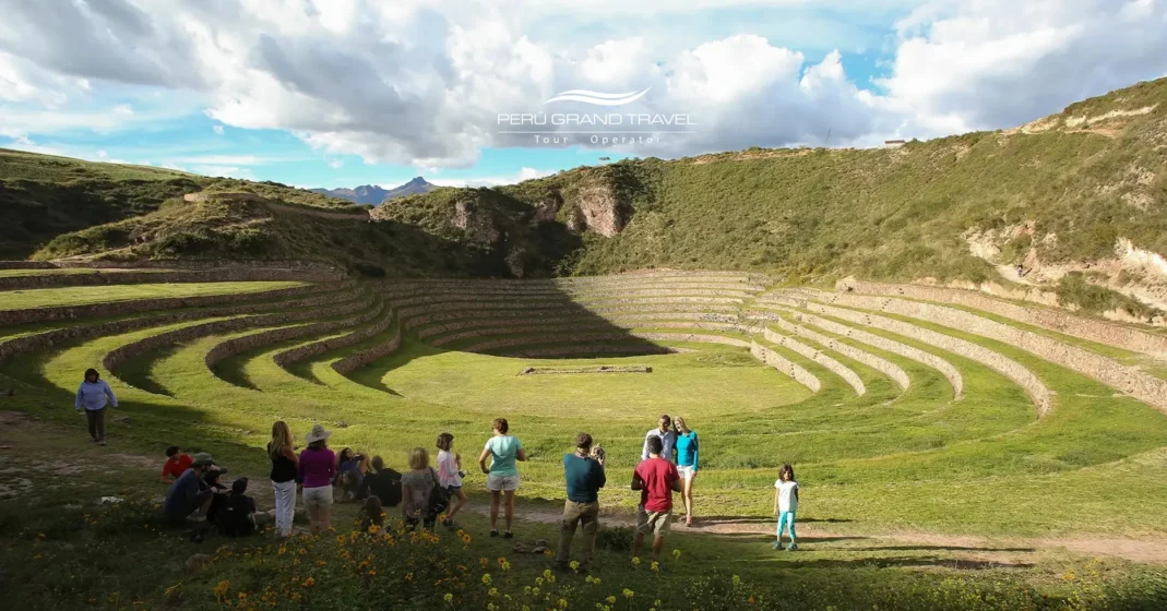 Half-Day Tours in Peru at Moray archaeological site, showing circular Inca terraces in the Sacred Valley with visitors exploring the ancient agricultural complex