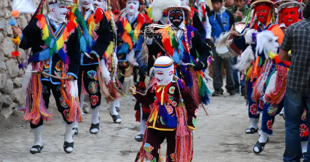 Masked dancers in Ollantaytambo during Bajada de Reyes procession in Peru’s Sacred Valley.