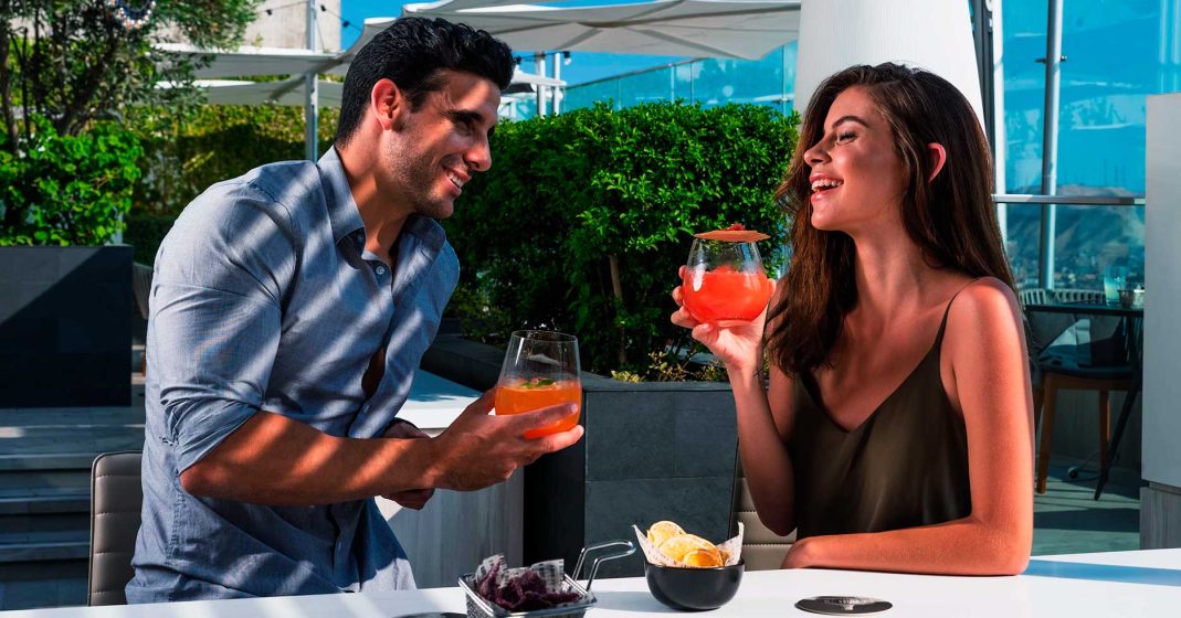 Exclusive experiences at luxury hotels in lima peru. Two tourists sipping Peruvian cocktails.
