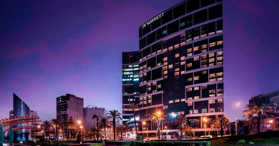 Luxury hotels in Lima, Peru - JW Marriott Lima view of the hotel, palm trees, and a purple sunset