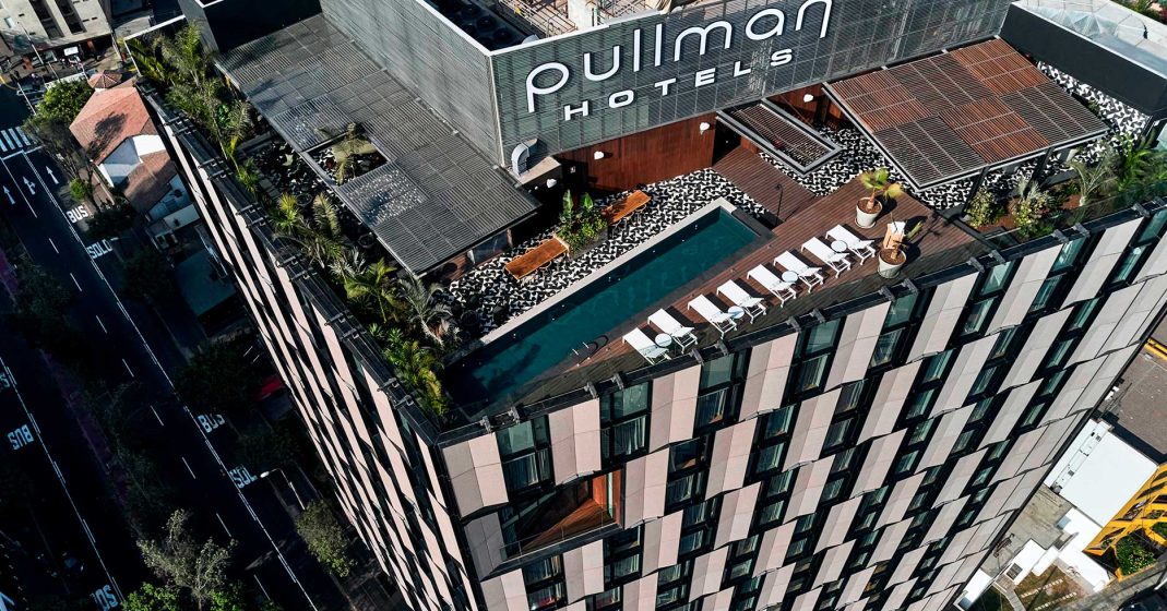Luxury hotels in Lima, Peru - Pullman Miraflores view of the building from above, the hotel name and the rooftop pool