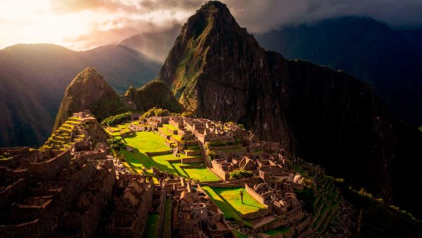 A luxury trip to Peru in Machu Picchu, overlooking the Inca buildings and the mountain behind it, shaped like an Inca.