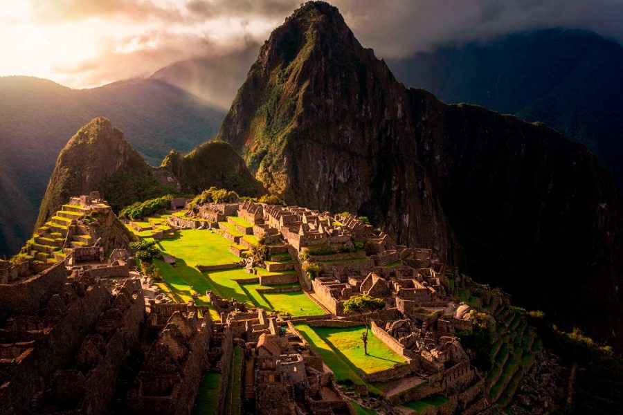 A luxury trip to Peru in Machu Picchu, overlooking the Inca buildings and the mountain behind it, shaped like an Inca.