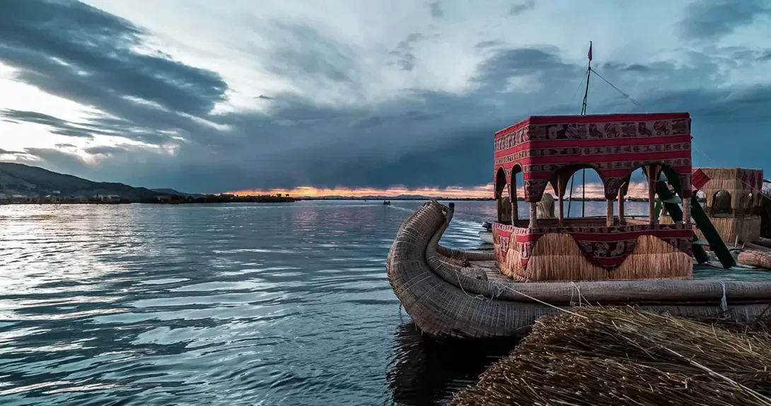 Lake Titicaca and a totora boat with a clear sky
