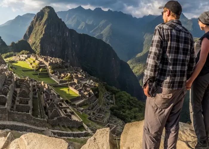 Couple holding hands looking at Machu Picchu