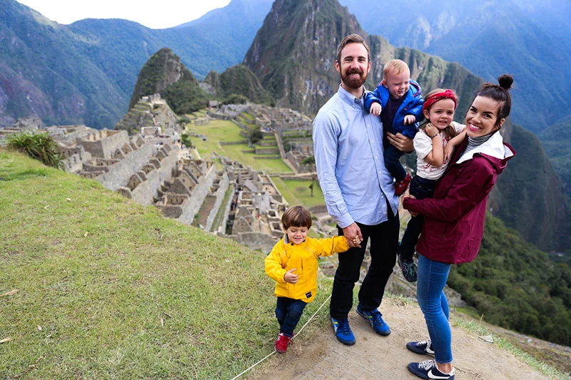 Family visiting Machupicchu with their young children.
